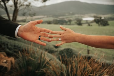 Wedding couple holding hands close up emotional moment outdoor