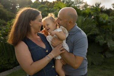 Family photo holding baby girl and laughing