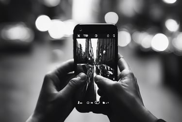 A black and white picture of someone using their phone