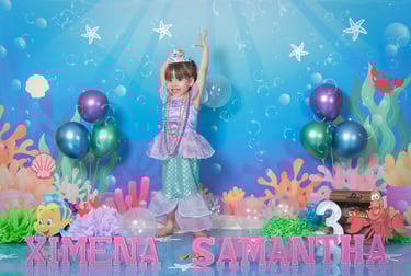 a little girl in a mermaid costume at a birthday party