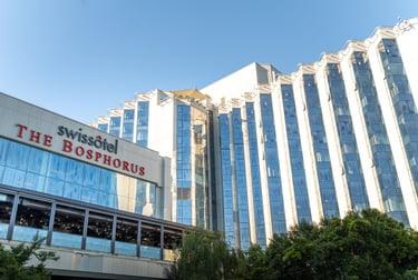 a large building with a clock tower in the background