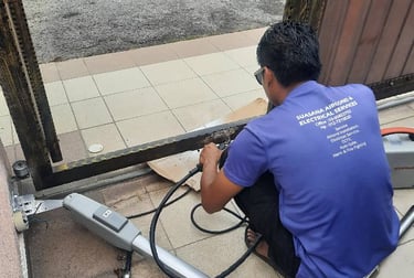 Suasana Security and Automations repairing automatic gate motor system.