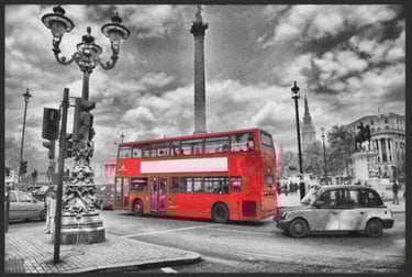 a red double decker bus parked in front of a statue of a man