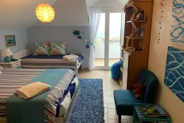water bedroom with two beds and a chair