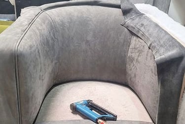 Gray velvet chair mid-reupholstery with tools on seat, showing custom work by Solo Home Decor.