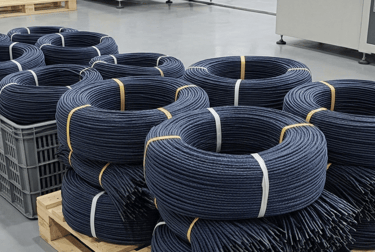 Precision cutting machine slicing a navy blue braided paper rope, by Hanxia Factory
