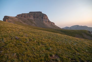  Uncompahgre Peak, the alpine tundra, and distant surrounding peaks aglow during summer sunrise