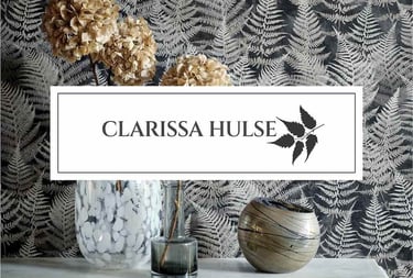 Clarissa Hulse fern wallpaper behind a marble mantel with dried hydrangeas and decorative glass vases.