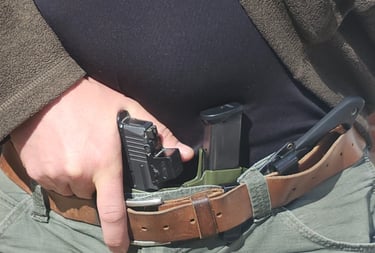 Man grips defensive firearm from concealment.