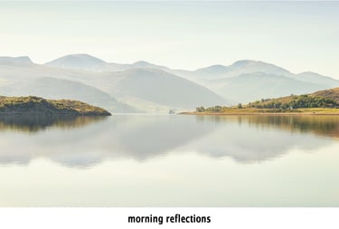 a loch with mountains in the background