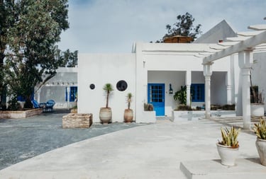 a white house with blue doors and a blue door