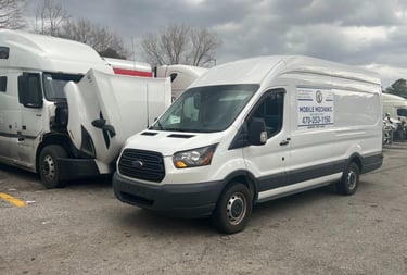 Mobile diesel mechanic performing engine repairs on Freightliner truck