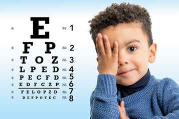 little boy reading eye chart