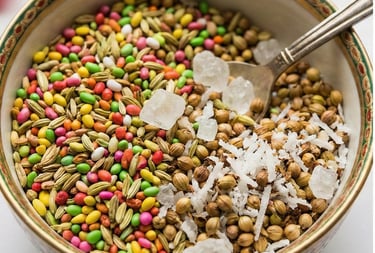 Traditional Indian mukhwas mouth freshener with fennel seeds, candy-coated seeds, and rock sugar in a decorative bowl.
