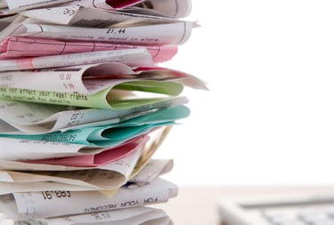 A stack of unordered receipts