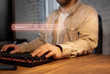 a man sitting at a desk with a keyboard and a keyboard
