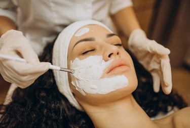 a woman getting a facial in a beauty salon