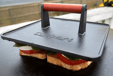 a sandwich with a grill press on top