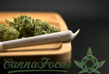 a marijuana leaf sitting on top of a wooden cutting board