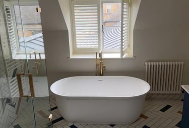 a bathtub with a large tub in the middle of a bathroom in pershore