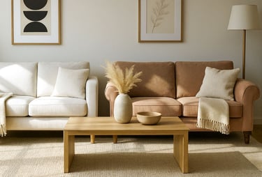 Side-by-side comparison of modern sofa with clean arms and traditional rolled-arm sofa in a refined, sunlit living room.