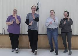 Johnny and participants practicing the principle of Body Upright with Rubber Duckies on their heads.