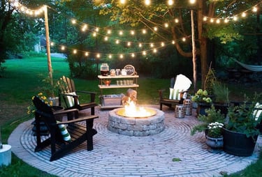 a fire pit with chairs and lights on it