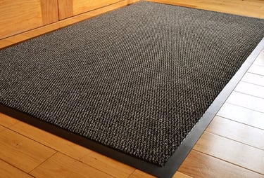 a black carpeted area rug with a black rug