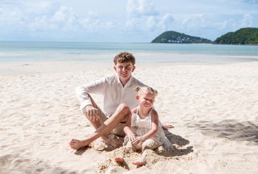 Brother and sister sitting together on Khem Beach