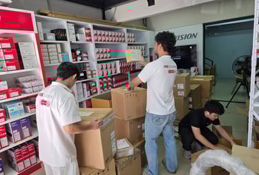 a group of people standing around a room with boxes and boxes