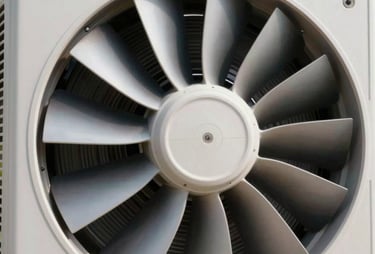A close-up photograph of a clean, high-performance residential AC condenser fan blades turning under bright, clear daylight, showcasing domestic comfort.