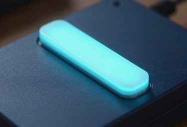 A close-up of a glowing cyan light bar on a dark blue tech device. Soft focus in the background, very futuristic and minimal.