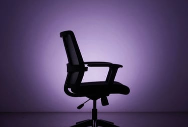 A minimalist photograph of a high-tech studio chair in a dark room, silhouetted against a purple-lit wall. The scene is quiet, professional, and sophisticated.