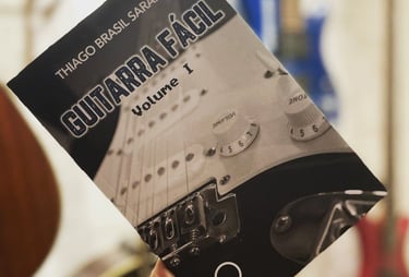 a person holding a guitar in their hand