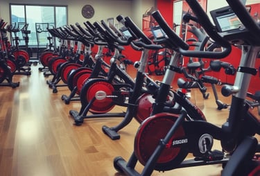 a gym with a row of stationary exercise bikes