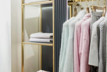 Organized closet with neatly arranged clothing (color coordinated) -  home organizing.