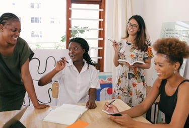 Group of multicultural women in a meeting setting strategic accountability goals