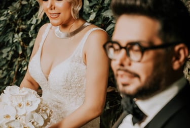 ride holding white orchids beside groom in black tuxedo, captured by Fred Art Studio