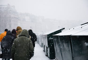 People walking in the snow along River Seine in Paris