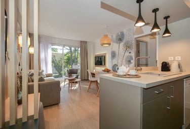 a kitchen with a table and chairs and a couch