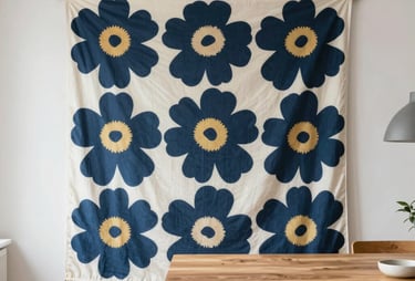 A bright, clean studio interior in Windermere, Durban, with a large Marimekko pattern hanging as a backdrop. Professional lighting and a minimalistic wooden table are present. Authentic and inspiring.