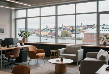 A wide shot of a modern, open-plan agency studio with Scandinavian furniture and large windows overlooking a Northern European / North American city.