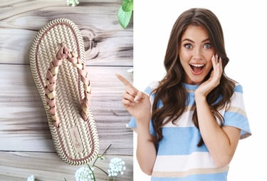 Excited woman pointing at a beige braided flip flop sandal on a wooden background.