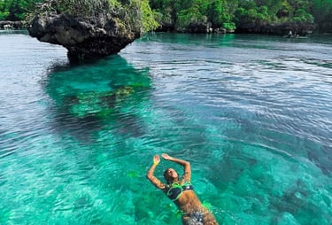 Tourist swimming in crystal-clear waters during Safari Blue Zanzibar boat tour, enjoying snorkeling and marine life adventure