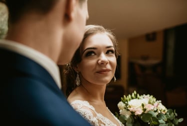 a bride and groom standing in front of a bride