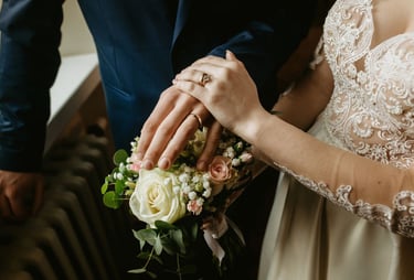 a bride and groom holding hands in a wedding ceremony