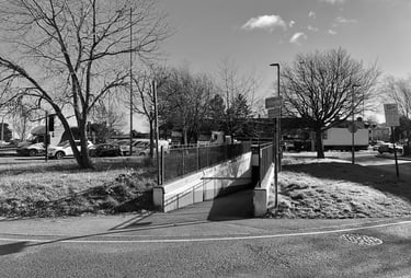 a black and white photo of an entrance to a pedestrian tunnel