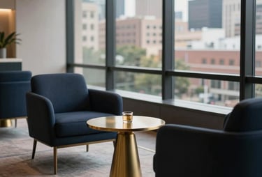 A high-end modern business lounge in Houston. Dark navy chairs, gold side tables, and a view of the city. Calm and professional environment. North American / Hispanic style.