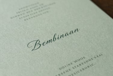 Minimalist photography of high-end wedding stationery featuring elegant typography and soft green colors, South American / Brazilian style.