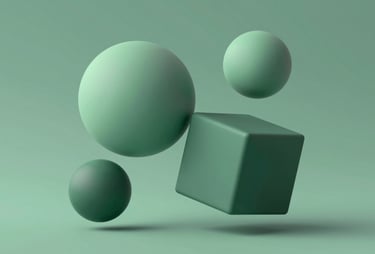 Abstract geometric shapes in 3D, spheres and cubes floating in a balanced arrangement. The surfaces are matte, using the colors #A7C5C3 and #3F5E5C. Clean, professional, and understated.